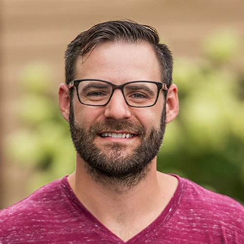 Dr. Paul Kaminski, a chiropractor at Kaminski Chiropractic PLLC, wearing glasses