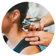 Close-up of a chiropractic neck adjustment using an instrument.