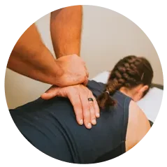 A chiropractor performing a manual back adjustment.